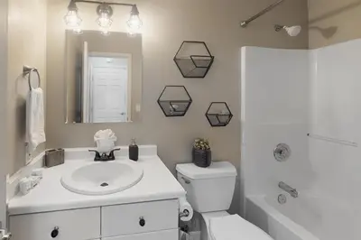 a bathroom with a sink and a toilet and a mirror at Salt Lick Sanctuary in Silverthorne