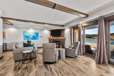 a living room with a couch and chairs and a fireplace at Corinthian Circle - Dillon in Dillon
