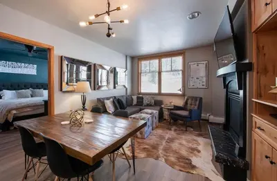 a living room with a table and a couch at Premium Unit 1403 - 2 Bedrooms - Zephyr Mountain condo in Winter Park