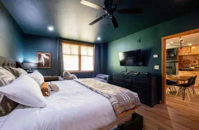 a bedroom with a large bed with a ceiling fan at Premium Unit 1403 - 2 Bedrooms - Zephyr Mountain condo in Winter Park