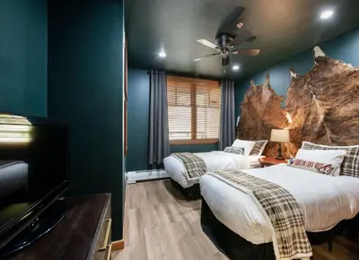 a hotel room with two beds and a tv at Premium Unit 1403 - 2 Bedrooms - Zephyr Mountain condo in Winter Park