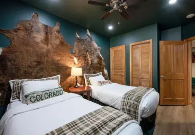 a bedroom with two beds and a wall with a large at Premium Unit 1403 - 2 Bedrooms - Zephyr Mountain condo in Winter Park
