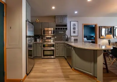 a kitchen with stainless steel appliances and a counter top at Premium Unit 1403 - 2 Bedrooms - Zephyr Mountain condo in Winter Park