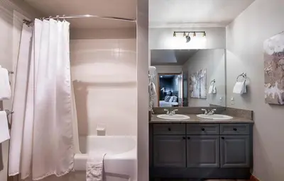 a bathroom with two sinks and a tub and a shower at Premium Unit 1403 - 2 Bedrooms - Zephyr Mountain condo in Winter Park