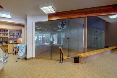 a glass wall in a room with a basketball hoop at Fraser's Mountain Fantasy in Fraser