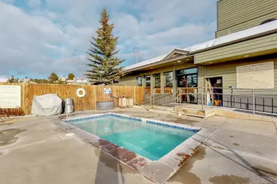 a swimming pool in front of a house at Fraser's Mountain Fantasy in Fraser