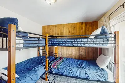 a bunk bed room with two bunk beds at Fraser's Mountain Fantasy in Fraser
