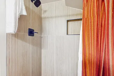 a bathroom with a shower with a shower curtain at Fraser's Mountain Fantasy in Fraser