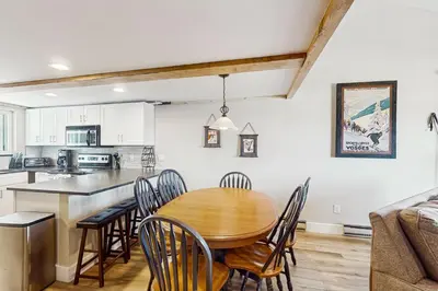 a kitchen and dining room with a wooden table and chairs at Fraser's Mountain Fantasy in Fraser