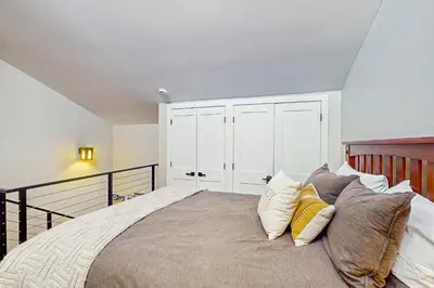 a bedroom with a large bed with white cabinets at Fraser's Mountain Fantasy in Fraser