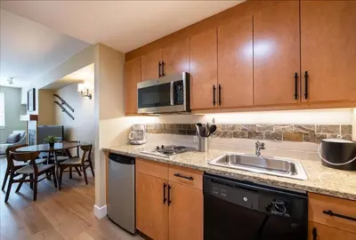 a kitchen with a sink and a kitchen with a table at Premium Unit 3522- Fraser Crossing Founders Pointe condo in Winter Park