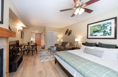 a bedroom with a bed and a living room at Premium Unit 3522- Fraser Crossing Founders Pointe condo in Winter Park