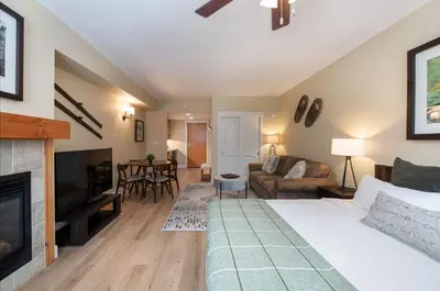 a living room with a bed and a fireplace at Premium Unit 3522- Fraser Crossing Founders Pointe condo in Winter Park