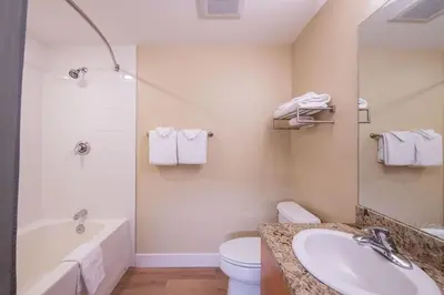 a bathroom with a tub and a toilet and a sink at Premium Unit 3522- Fraser Crossing Founders Pointe condo in Winter Park