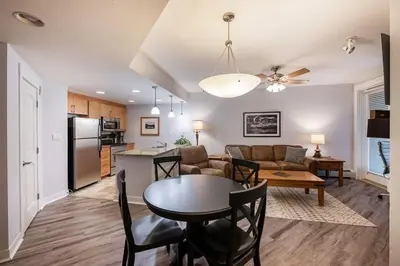 a kitchen and a living room with a table and a couch at Premium Unit 3513- Fraser Crossing Founders Pointe condo in Winter Park