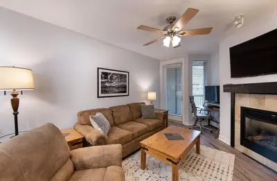 a living room with a couch and a fireplace at Premium Unit 3513- Fraser Crossing Founders Pointe condo in Winter Park