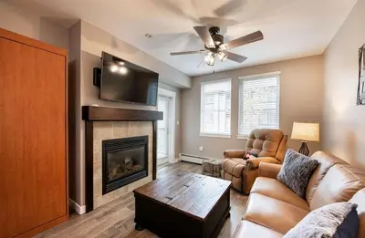 a living room with a couch and a fireplace at Premium Unit 3519- Fraser Crossing Founders Pointe condo in Winter Park