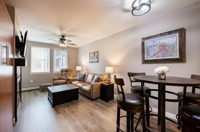 a living room with a couch and a table at Premium Unit 3519- Fraser Crossing Founders Pointe condo in Winter Park