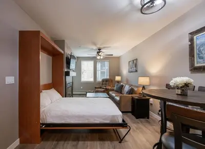 a bedroom with a bed and a living room at Premium Unit 3519- Fraser Crossing Founders Pointe condo in Winter Park