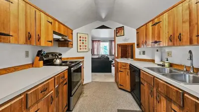 a large kitchen with wooden cabinets and a sink at Manorhouse Hideaway in Dillon