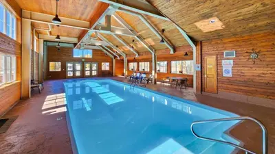 a large swimming pool in a room with wooden walls at Manorhouse Hideaway in Dillon