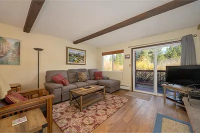 a living room with a couch and a tv at Hi Country Haus Unit 1803 in Winter Park