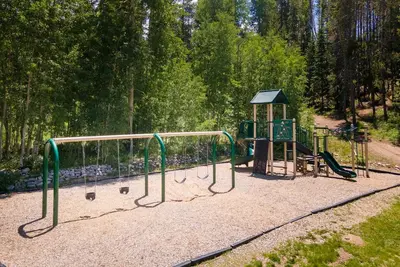 a playground in a park with a play equipment at Hi Country Haus Unit 1803 in Winter Park