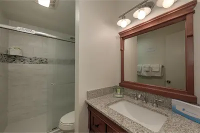a bathroom with a sink and a shower and a mirror at Hi Country Haus Unit 1803 in Winter Park