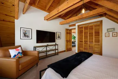 a bedroom with a bed and a couch and a television at 980 Mulligan in Fraser