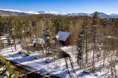 an aerial view of a cabin in the woods in the snow at 980 Mulligan in Fraser