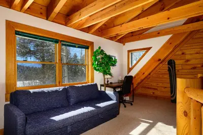 a living room with a couch in a cabin at 980 Mulligan in Fraser