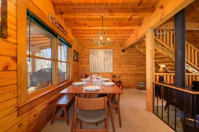 a dining room with a table in a cabin at 980 Mulligan in Fraser