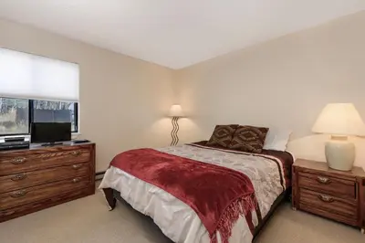a bedroom with a bed and a flat screen tv at Meadow Ridge Court 18 Unit 4 in Fraser