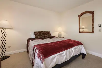 a bedroom with a bed and a mirror at Meadow Ridge Court 18 Unit 4 in Fraser