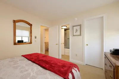 a bedroom with a bed with a red blanket on it at Meadow Ridge Court 18 Unit 4 in Fraser