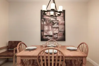 a dining room table with chairs and a painting on the wall at Meadow Ridge Court 18 Unit 4 in Fraser