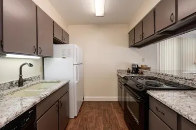 a kitchen with granite counter tops and a white refrigerator at Meadow Ridge Court 18 Unit 4 in Fraser
