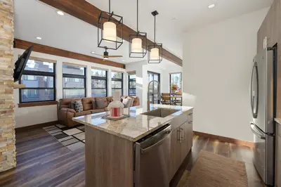 a kitchen and living room with a couch at Arrow at Winter Park Unit 202 in Winter Park