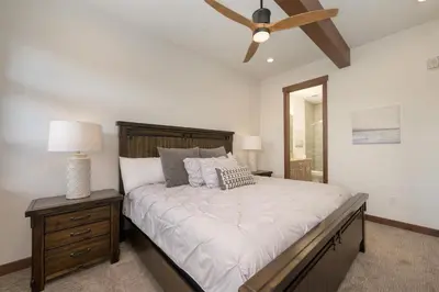 a bedroom with a large bed and a ceiling fan at Arrow at Winter Park Unit 202 in Winter Park