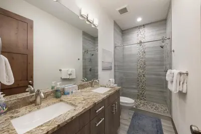 a bathroom with two sinks and a shower at Arrow at Winter Park Unit 202 in Winter Park