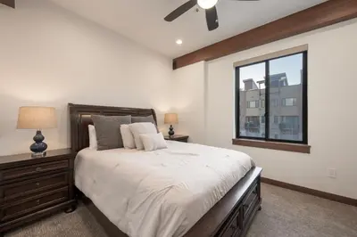 a bedroom with a large bed and a window at Arrow at Winter Park Unit 202 in Winter Park