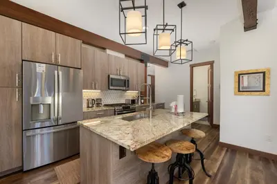 a kitchen with a counter and a refrigerator at Arrow at Winter Park Unit 202 in Winter Park