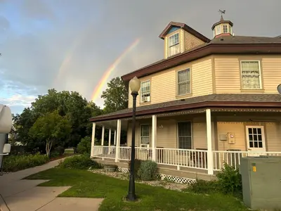a rainbow in the sky above a house at The Currier Inn in Greeley