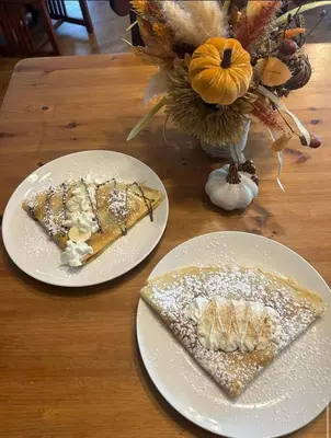 two plates of food on a wooden table at The Currier Inn in Greeley