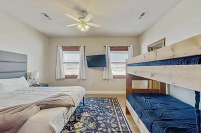 a bedroom with two beds and a ceiling fan at Silver Sage Sanctuary in Granby