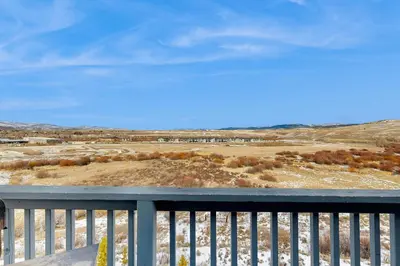 a view of a field from a balcony at Silver Sage Sanctuary in Granby