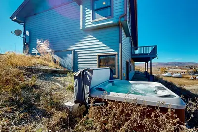 a bath tub sitting outside of a house at Silver Sage Sanctuary in Granby