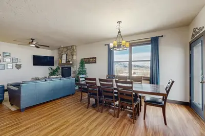 a dining room with a table and chairs and a couch at Silver Sage Sanctuary in Granby