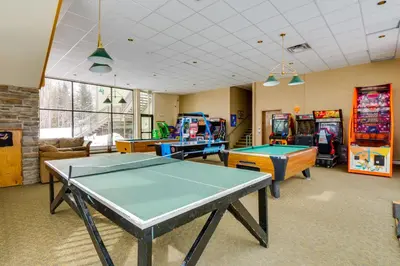 a room with ping pong tables and arcade games at Mtn-View Condo with Community Perks in Silverthorne in Silverthorne