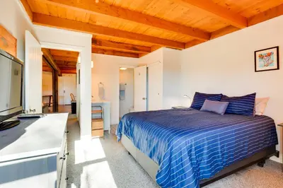 a bedroom with a blue bed and a kitchen at Mtn-View Condo with Community Perks in Silverthorne in Silverthorne